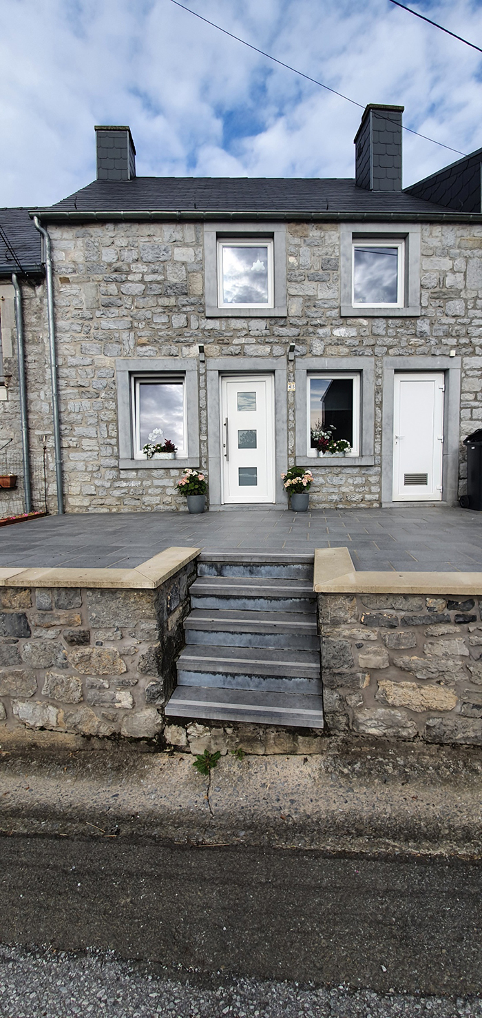 Une photo de la façade et de la terrasse avant